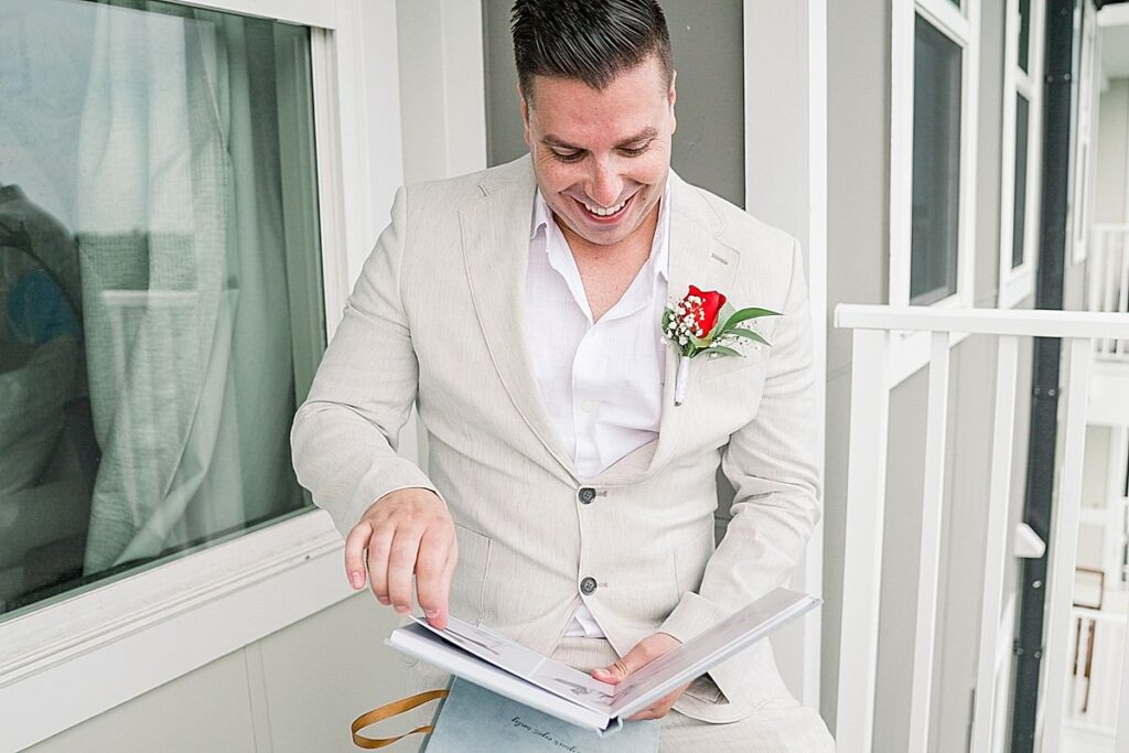 groom looking at bridal boudoir album