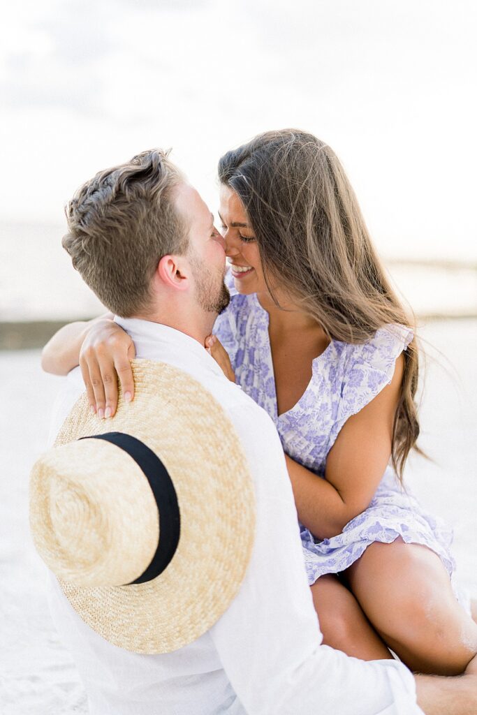 couple touching noses at st. petersburg beach engagement session