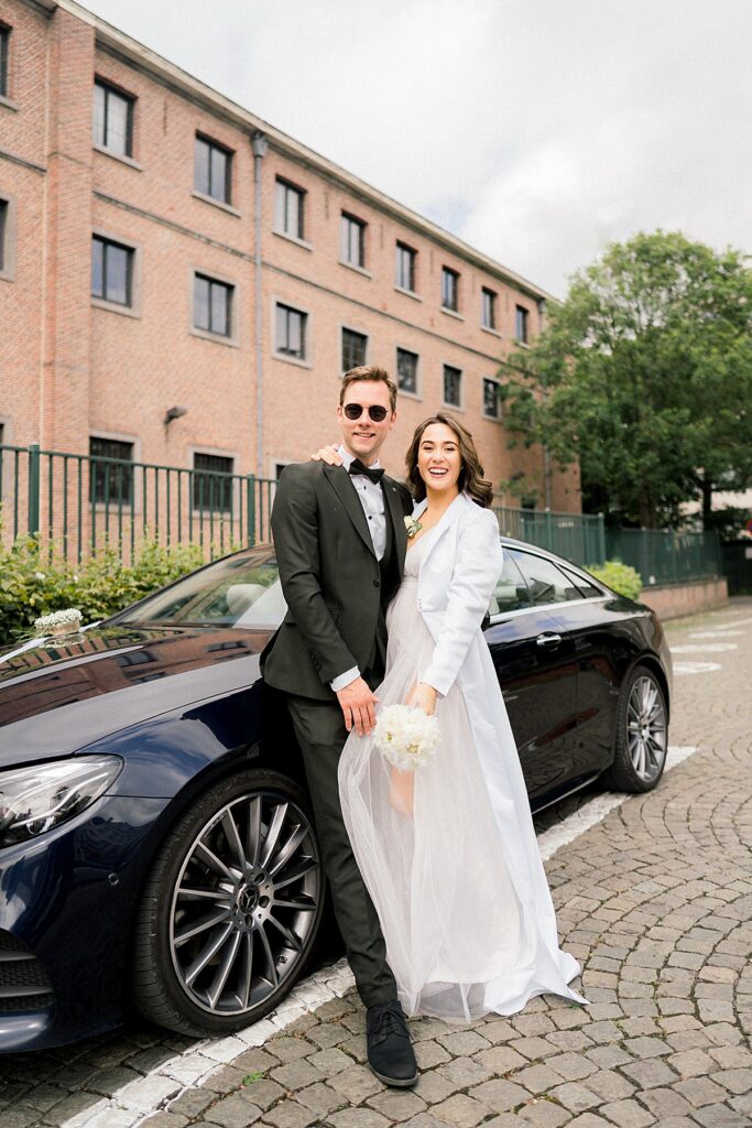 bride and groom on mercedez car