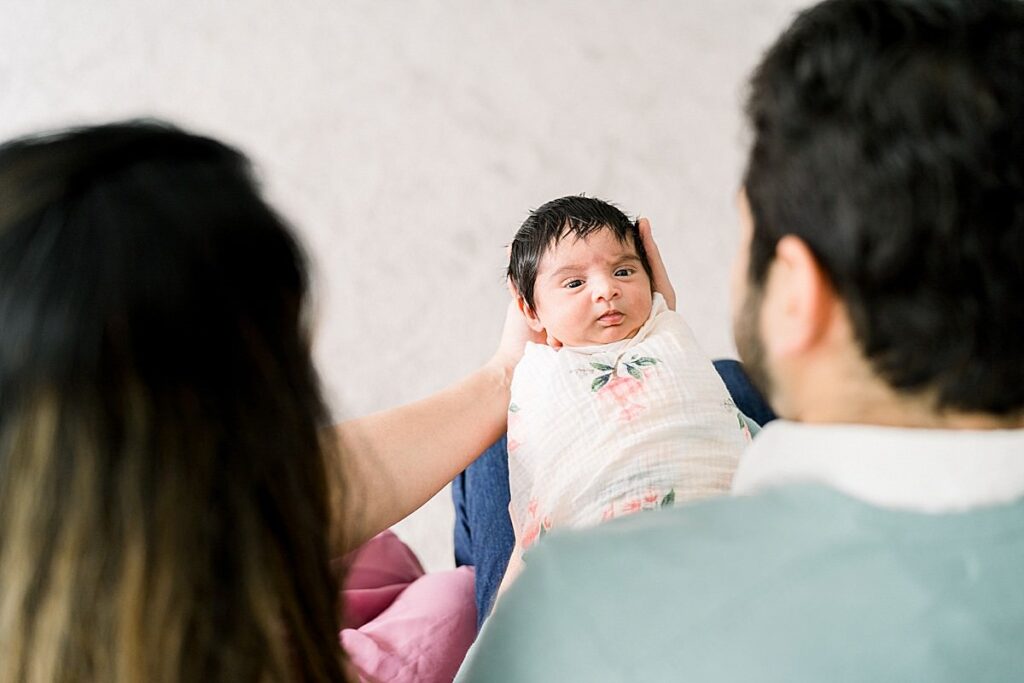 parents looking at baby In-Home Newborn Session 