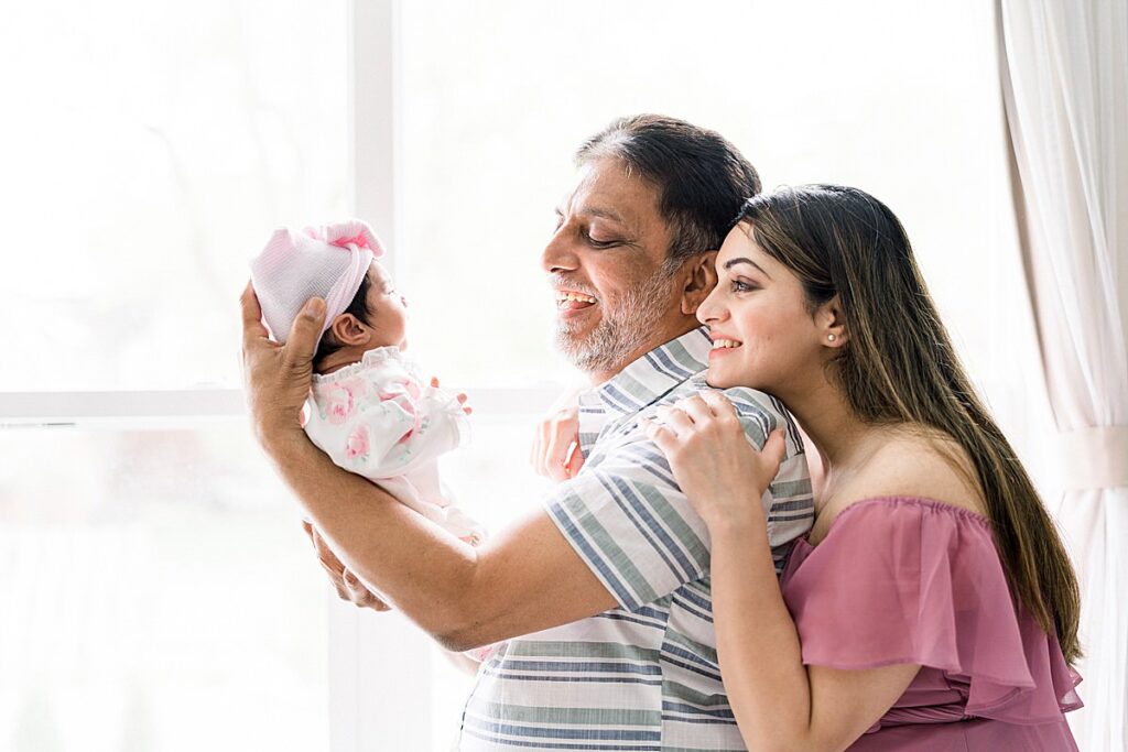 granddad holding baby at In-Home Newborn Session