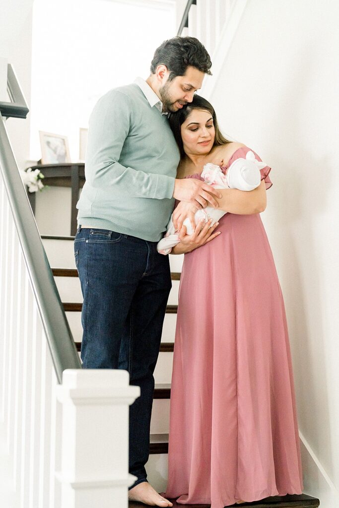 couple holding baby In-Home Newborn Session