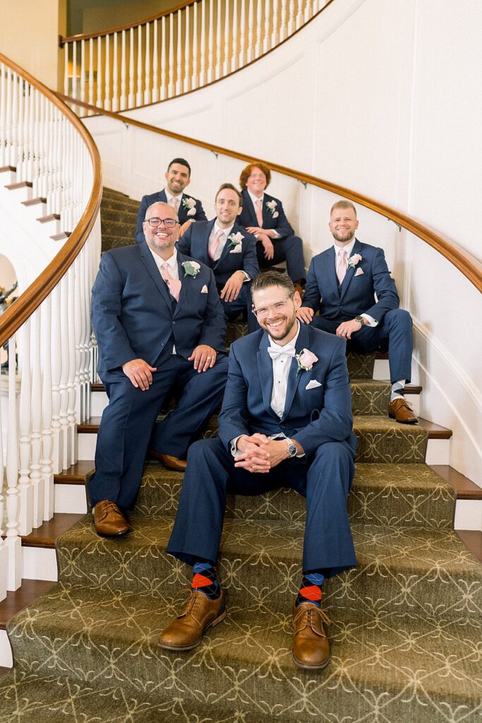 groom and groomsman on stairs